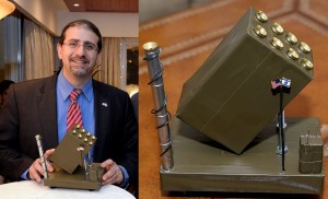 Ambassador Daniel Shapiro proudly displays the disgusting menorah in the shape of an Iron Dome missile battery, complete with tiny flags from the US and Israel.