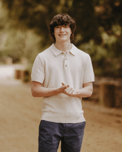  Adam Raine with a soft focus background of a tree lined road. 