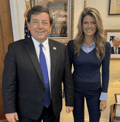 An awkward picture of Eagle Ed Martin and Lindsey Halligan posing in his office.